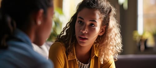 Teen Girl High Schooler Converses With Psychologist In Office.