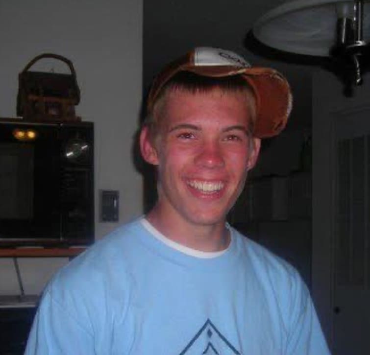 Stuart Eiken wearing a baseball cap and blue t-shirt